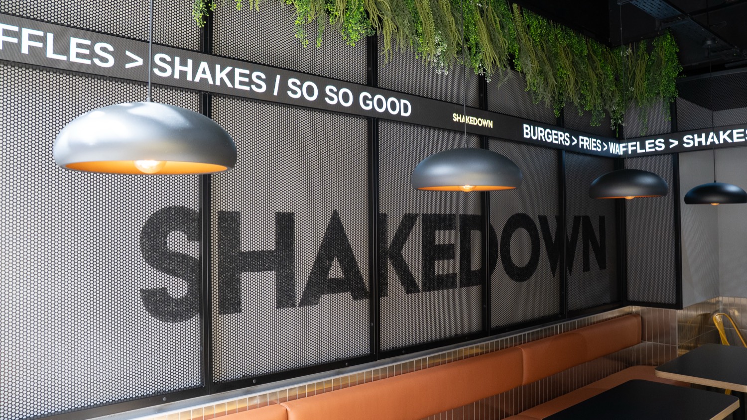 The finished Ticker Tape LED installation lit across the feature wall at Shakedown in Edinburgh